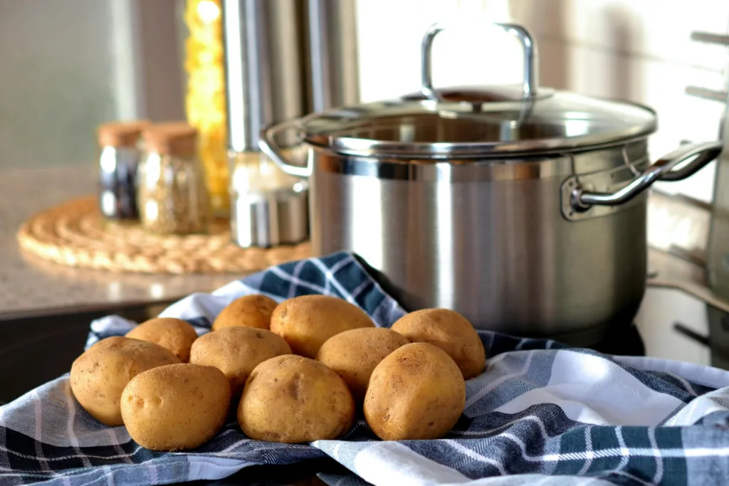 Potatoes Beside Stainless Steel Cooking Pot