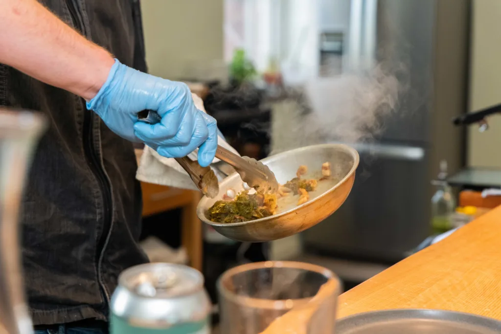 A chef preparing a dish at the Oak Table & Bar in Augusta, Nain USA