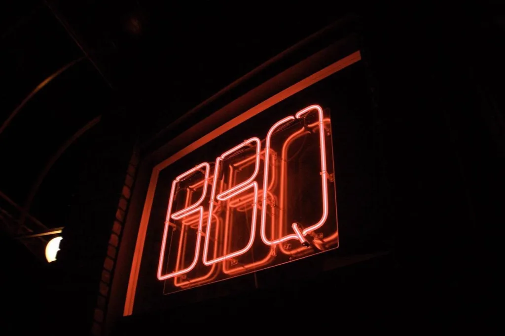 A neon BBQ sign at the front of the Riverfront Bar & Grille in Augusta Maine, USA